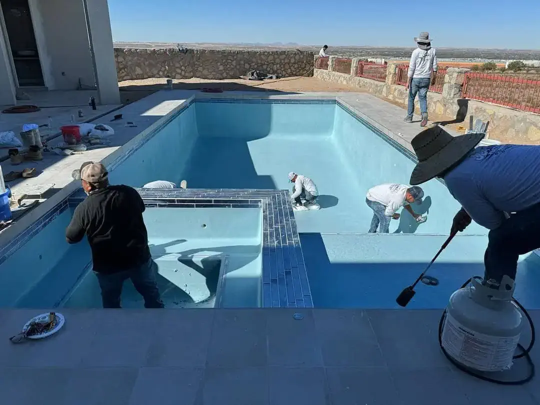 Pool under construction with workers