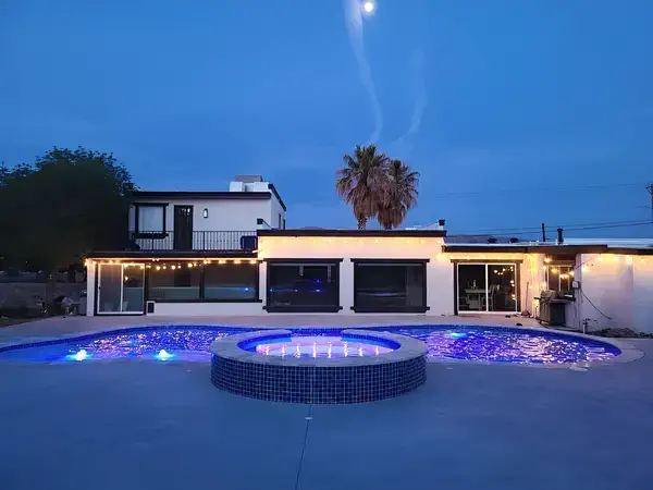 Pool with purple lighting and firepit